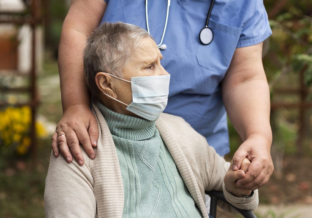 female-nurse-holding-older-woman-s-hand