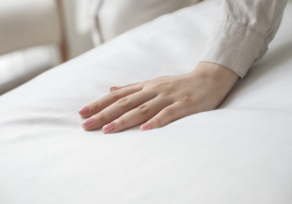 Hand on a soft duvet Hand on a soft duvet